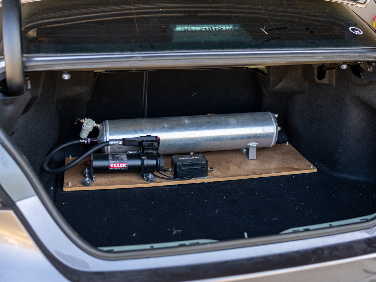 Before air suspension rework with tank and compressor mounted on wood panel