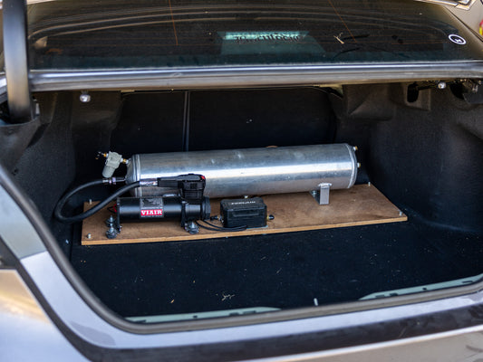 Before air suspension rework with tank and compressor mounted on wood panel