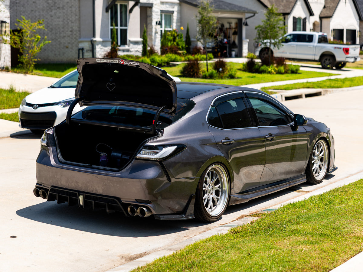 Gray sedan with custom air suspension trunk setup and dual compressors
