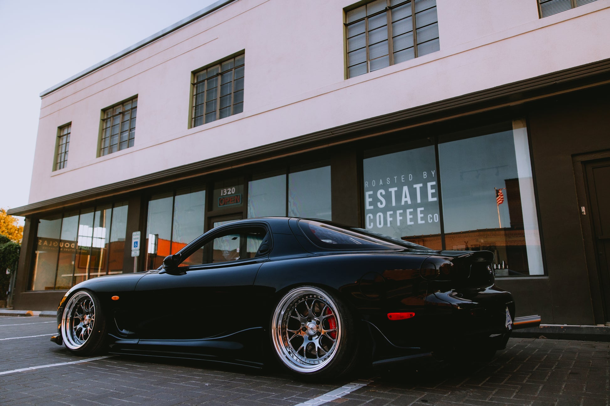 Modified Mazda RX-7 FD3S parked with Wilwood brake upgrade visible through wheels